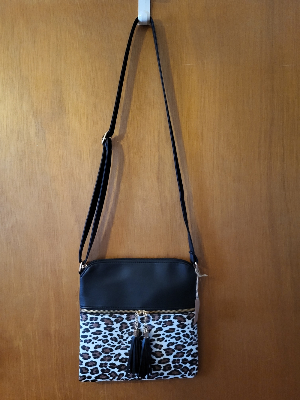 Black and Leopard Print Crossbody Bag with Tassel Accent